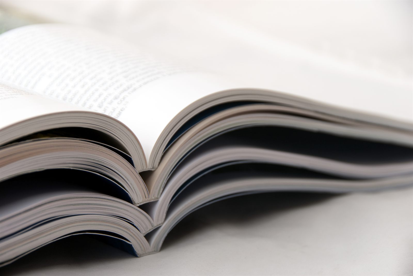 Open book lying on a white table